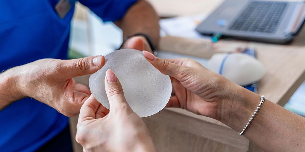 Plastic surgeon showing a breast implant