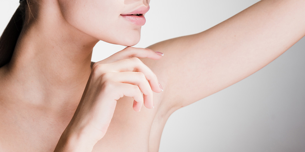 Woman looking at her underarm area