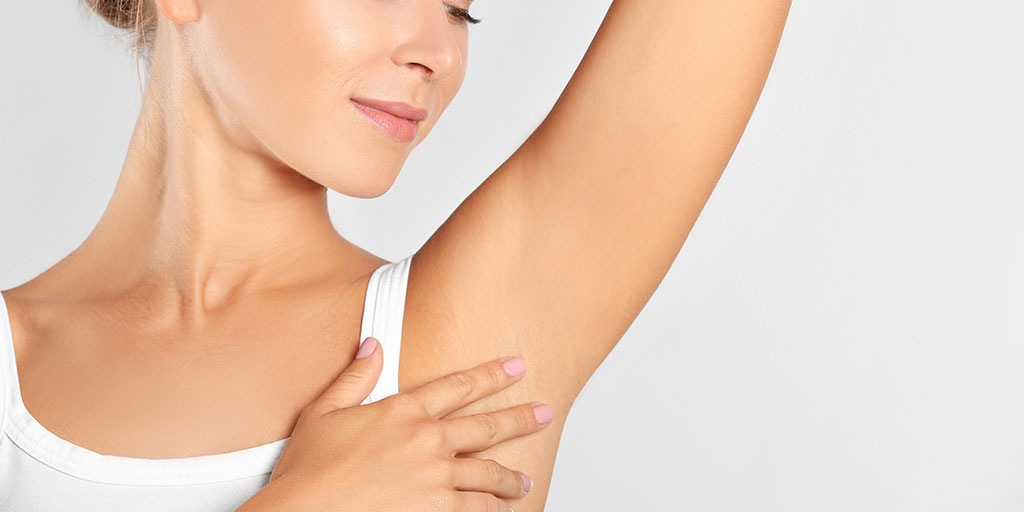 woman touching her armpit