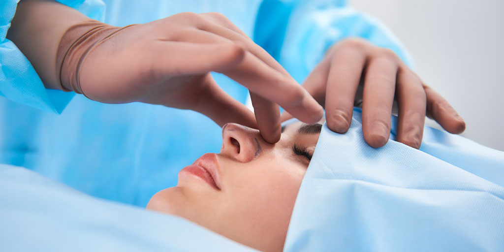 Surgeon touching patients nose