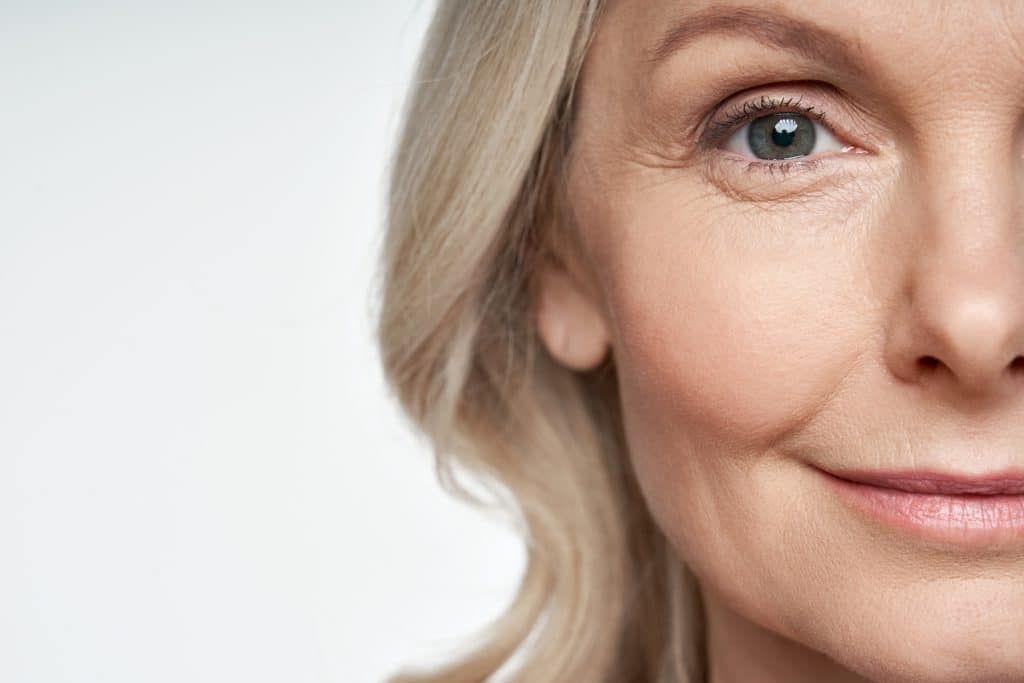 Close-up of the right side of a woman’s face, showing her eye, cheek, and part of her lips and nose.